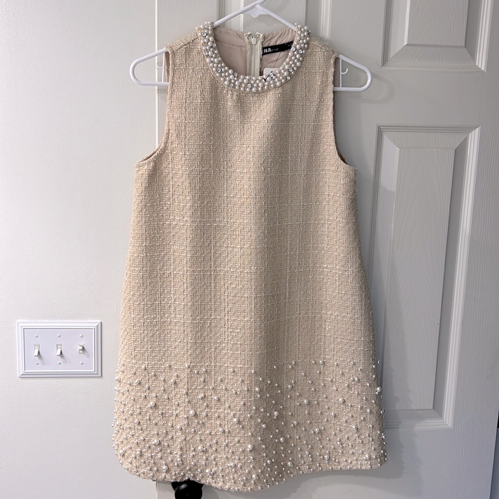 Tweed dress with pearl accents along the collar and bottom.